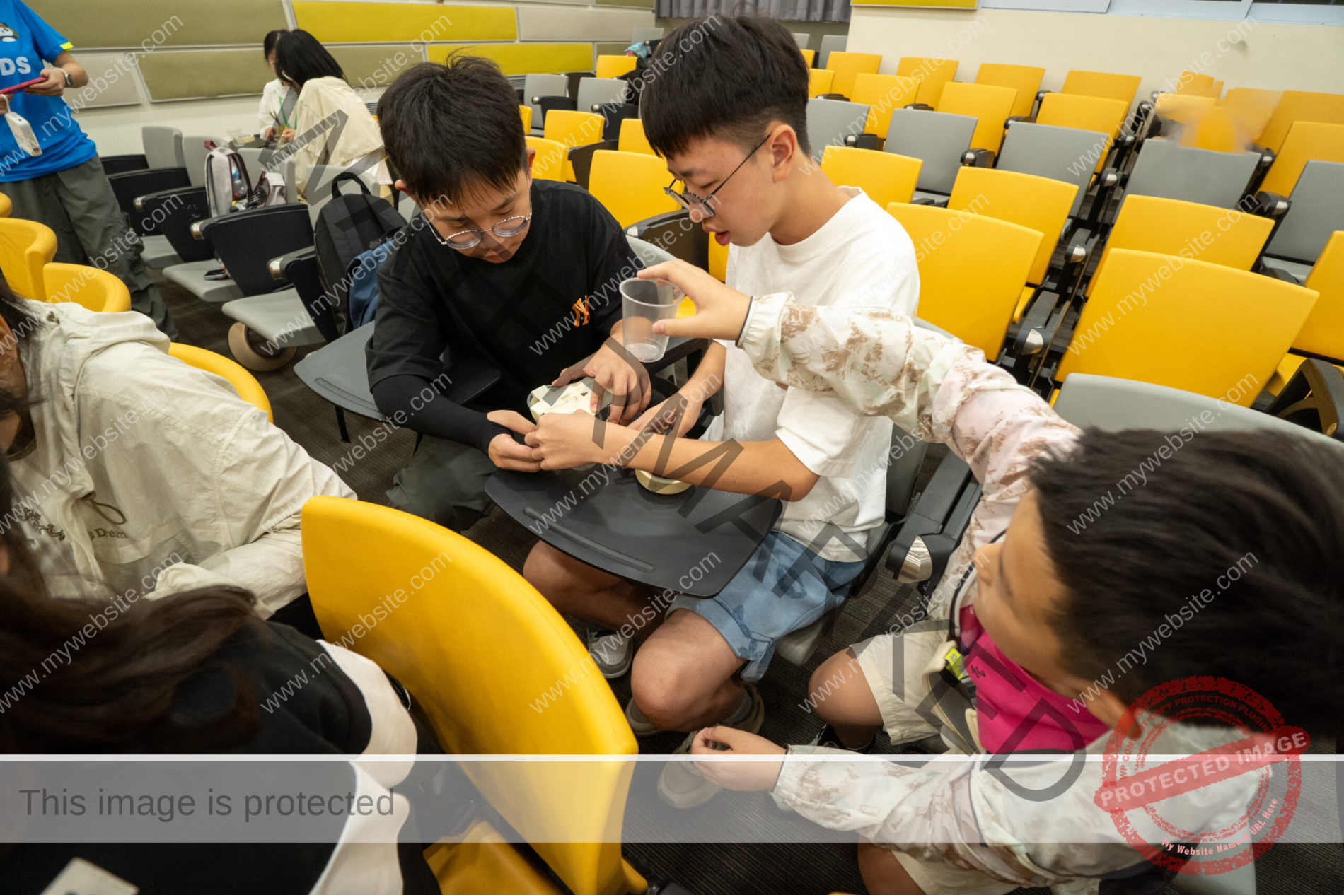 students building a buoyancy vessel during a hands-on project on a STEAM programme.